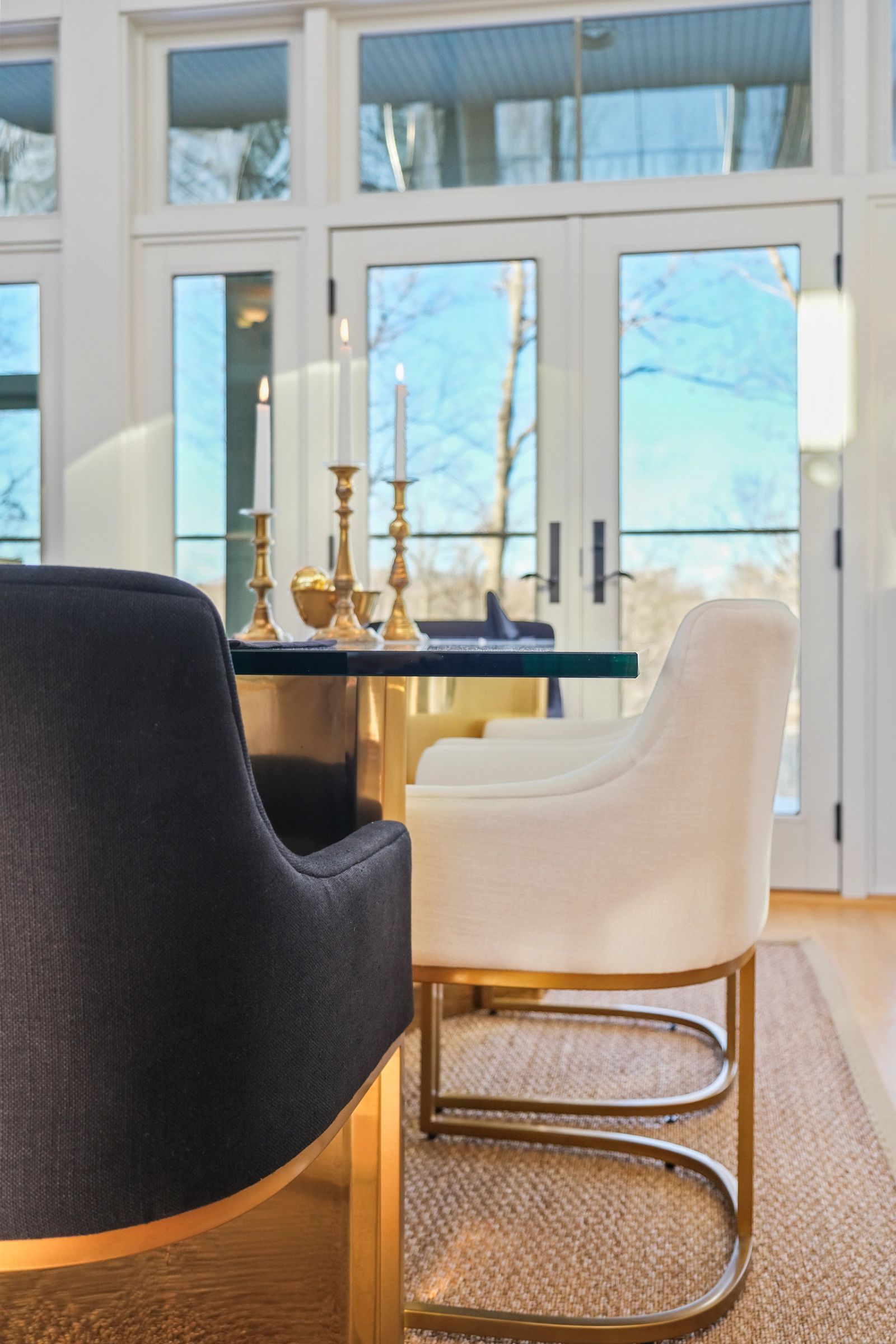 Dining area beside full-height windows