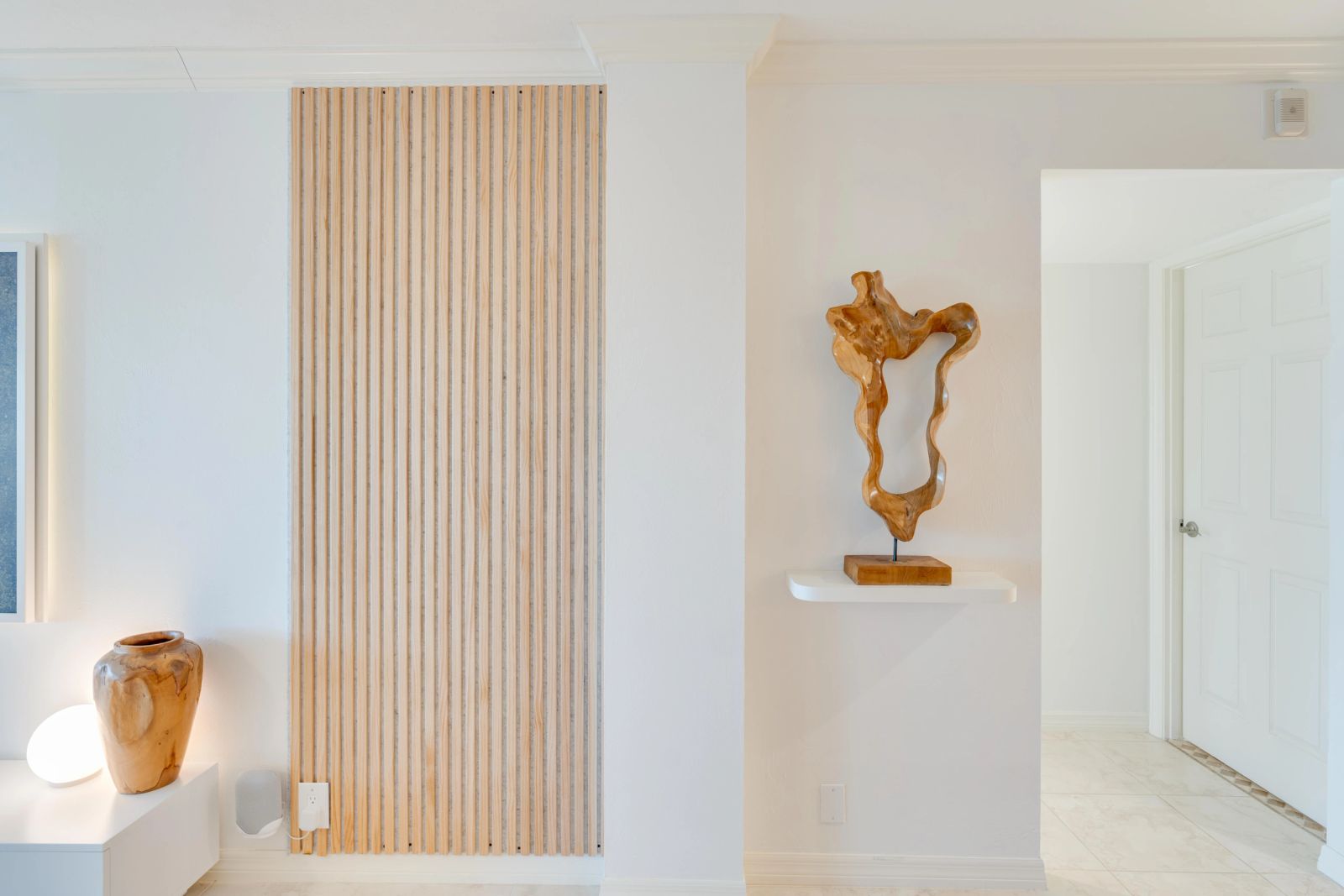 Artwork displayed in a timber-detailed entrance