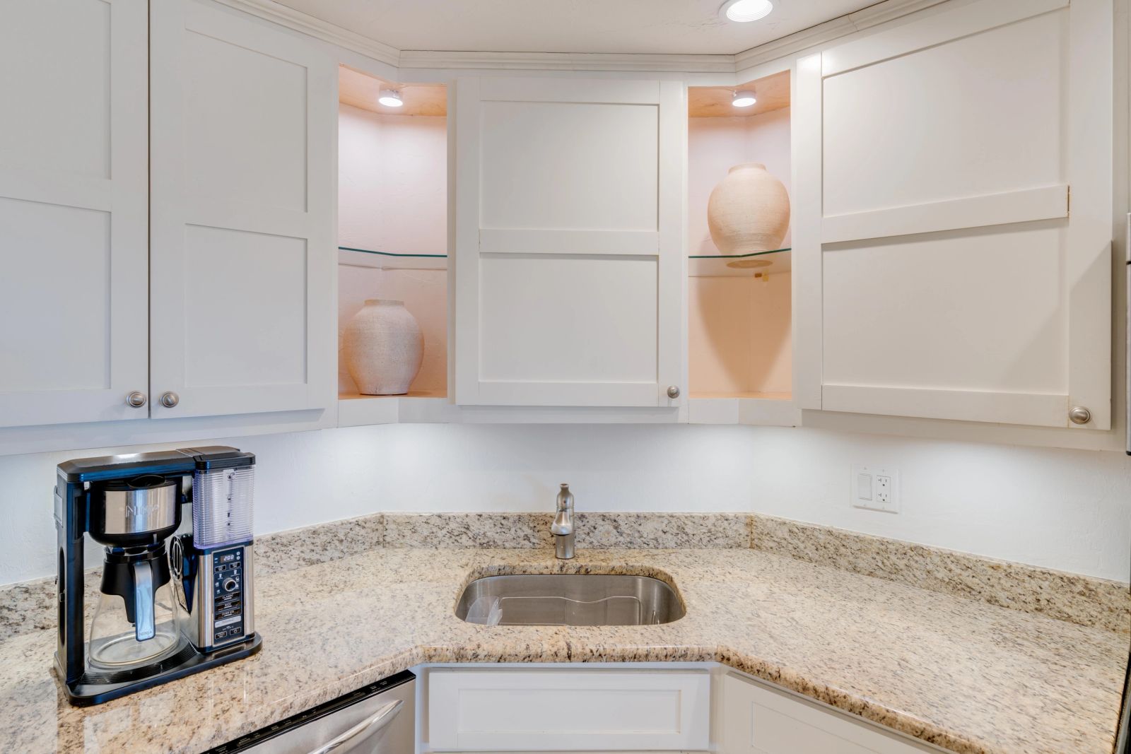 Compact kitchen with pale cabinetry and a stone worktop