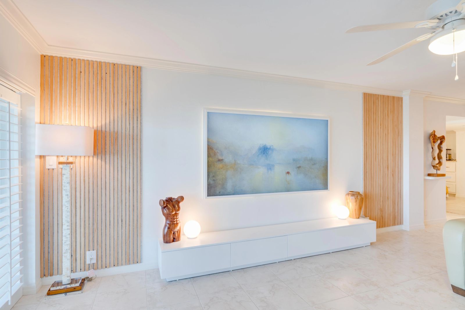 Screen and sculpture on a timber-detailed feature wall