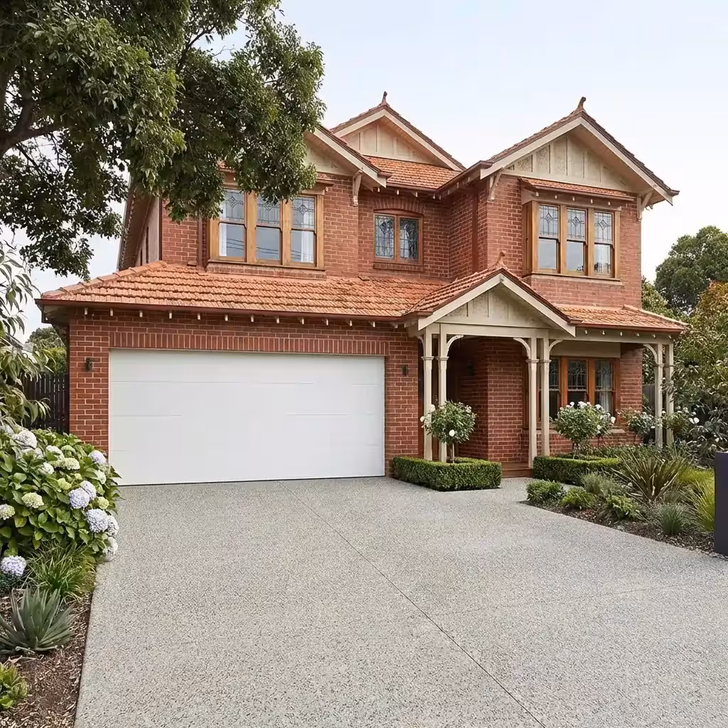 Modern garage door with black frame and wooden panels on a white house facade.