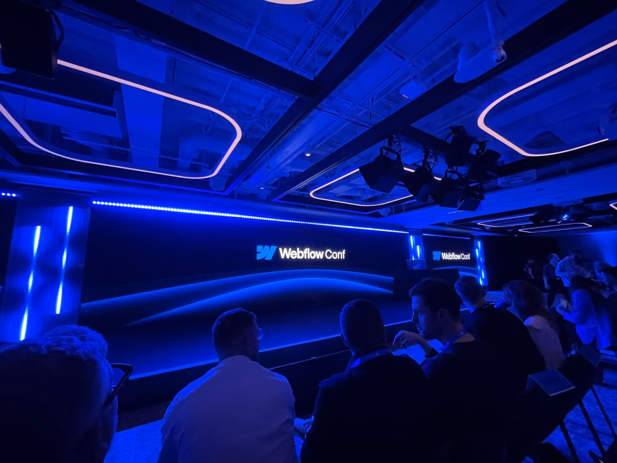 Blue-lit stage at Webflow Conference London.