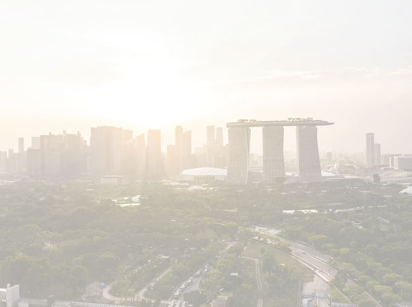 Sunset view over Singapore skyline with Marina Bay Sands and lush greenery in the foreground.