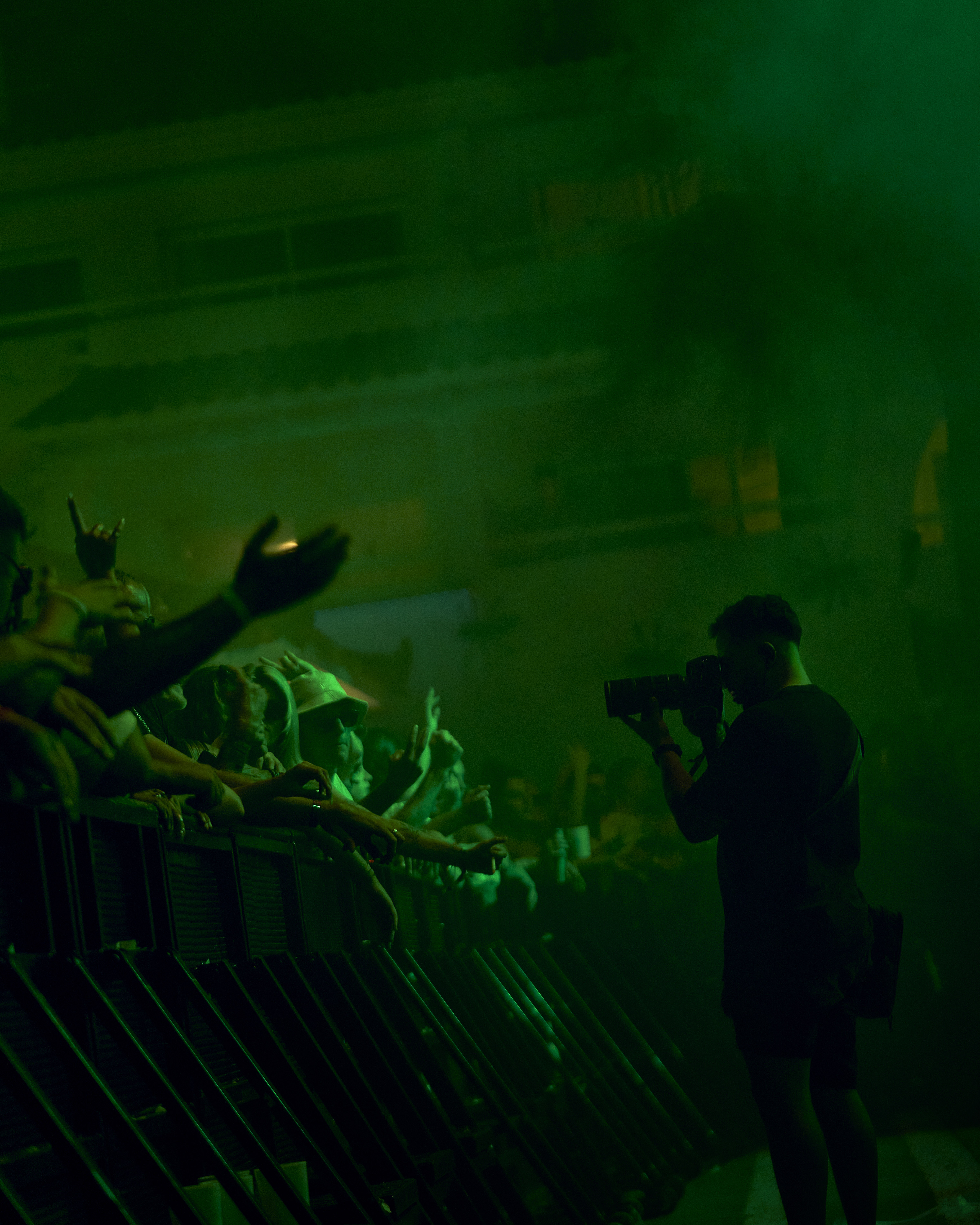 Handsome young man in orange classes on clear sky background.