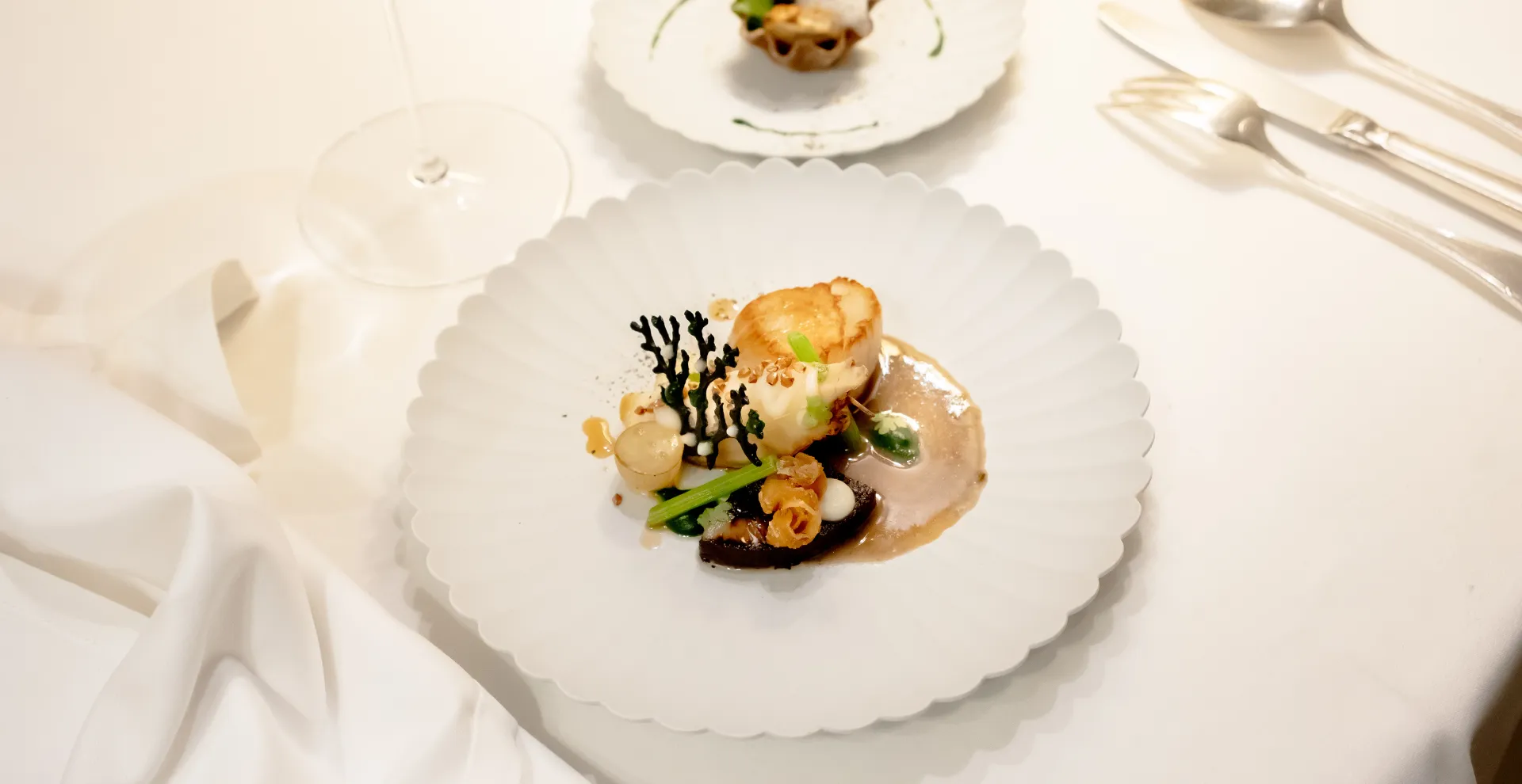 Refined gourmet dish served during a culinary experience offered by Beauvallon Collection.