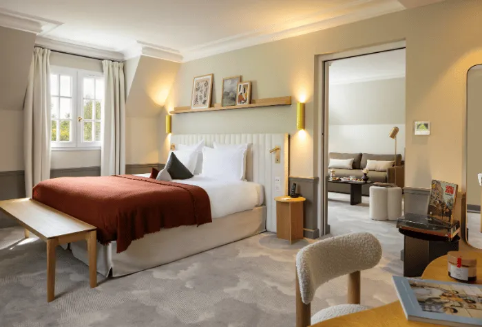 Signature suite with bedroom and separate living room at Hostellerie La Briqueterie & Spa in Champagne.