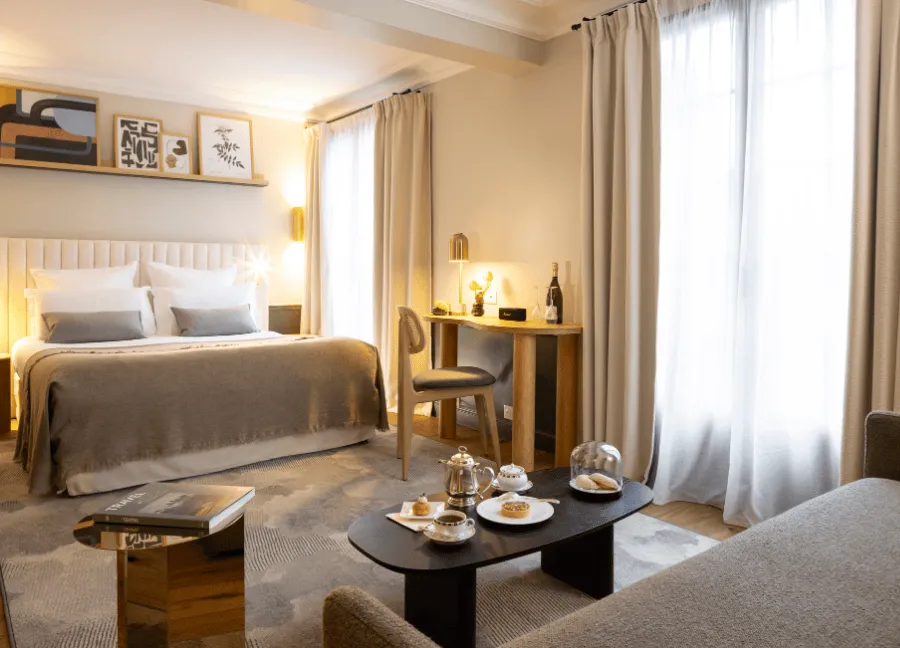 Camera deluxe con terrazza, letto matrimoniale e area salotto presso l'Hostellerie La Briqueterie & Spa in Champagne.