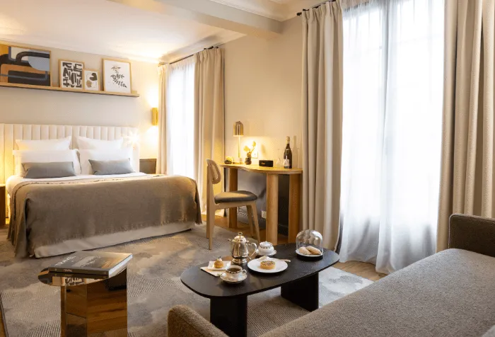 Deluxe Room with bright terrace with double bed and lounge area at Hostellerie La Briqueterie & Spa.