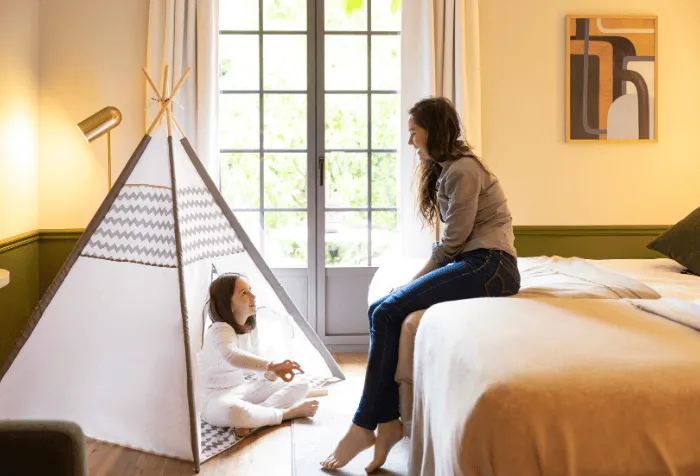 Family room with children's corner and tipi tent at Hostellerie La Briqueterie & Spa.