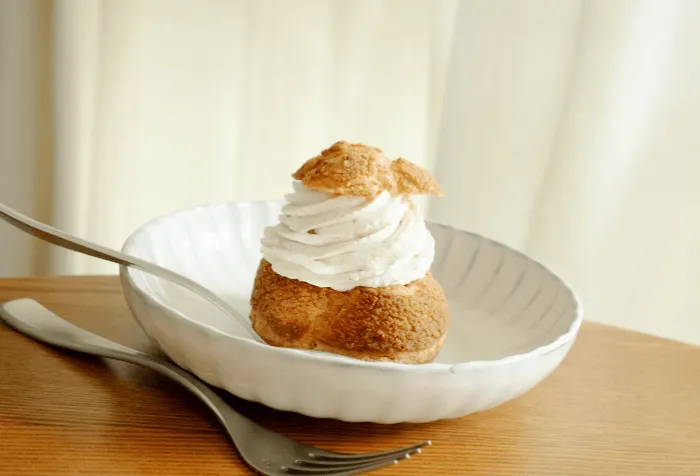 Cream-topped dessert served on a plate at the restaurant.