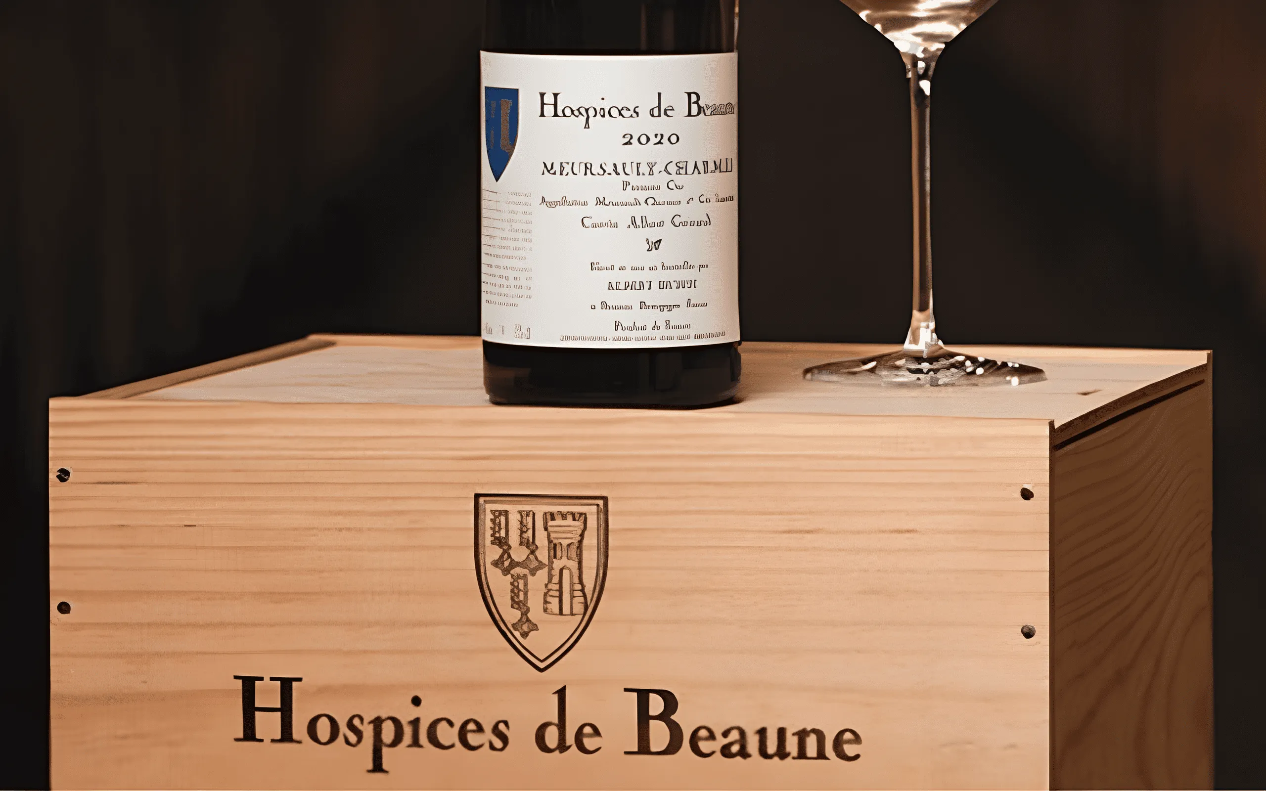 Meursault-Genevrières wine bottle from the Hospices de Beaune placed on a wooden case.