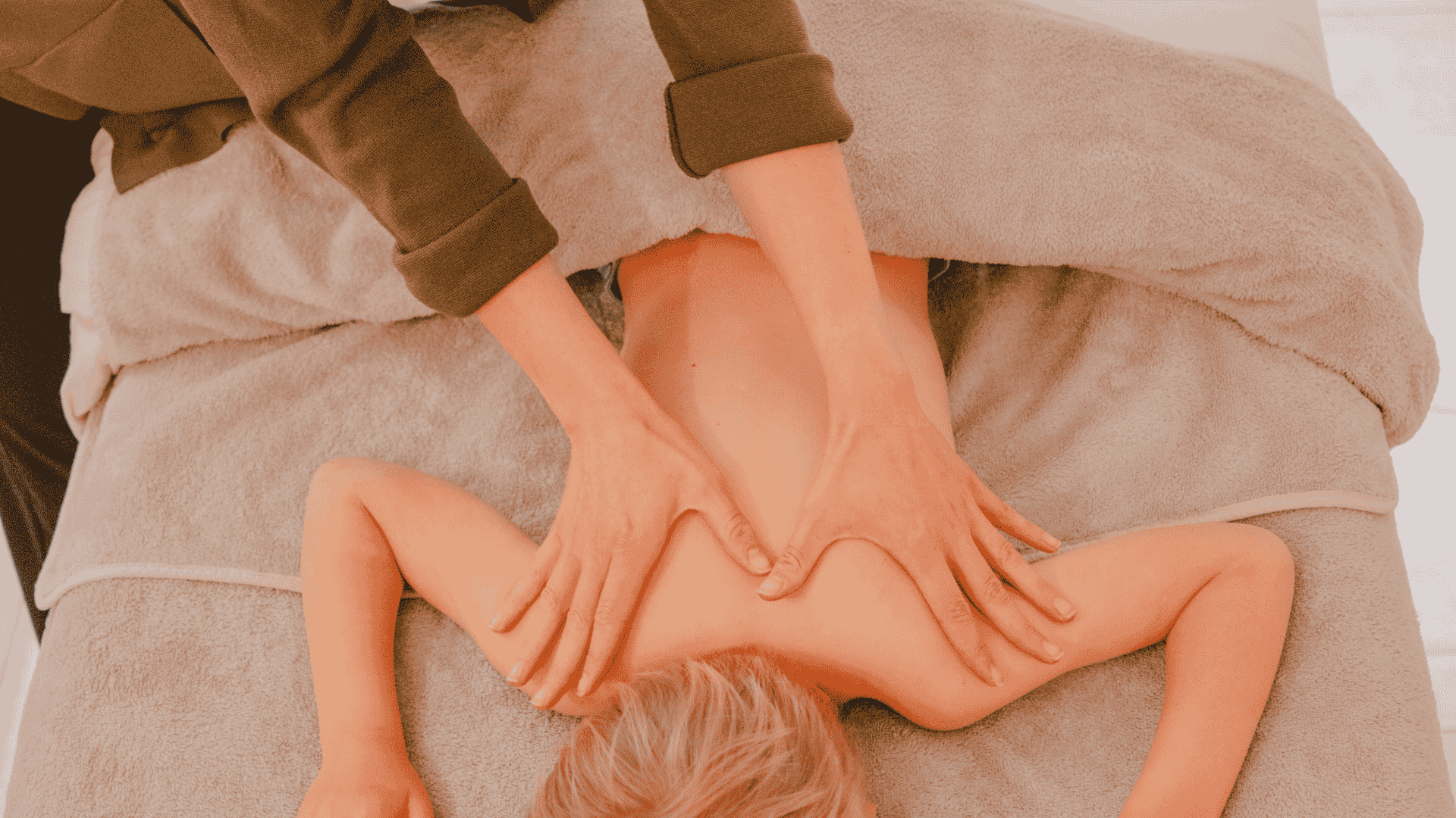 Top view of a person receiving a relaxing back massage in a spa or wellness center.