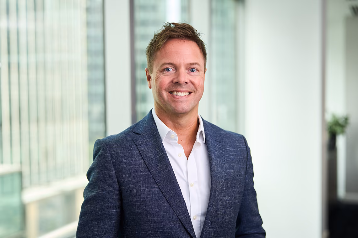 Stephen Hender, Chief Product and Technology Officer at WSD Group, smiling in an office wearing a navy blazer