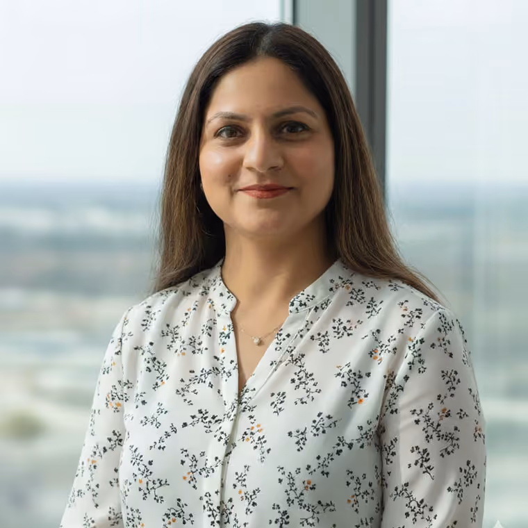 Akriti Kapil, Senior Human Resources Specialist at WSD Group, smiling in an office wearing a white floral blouse