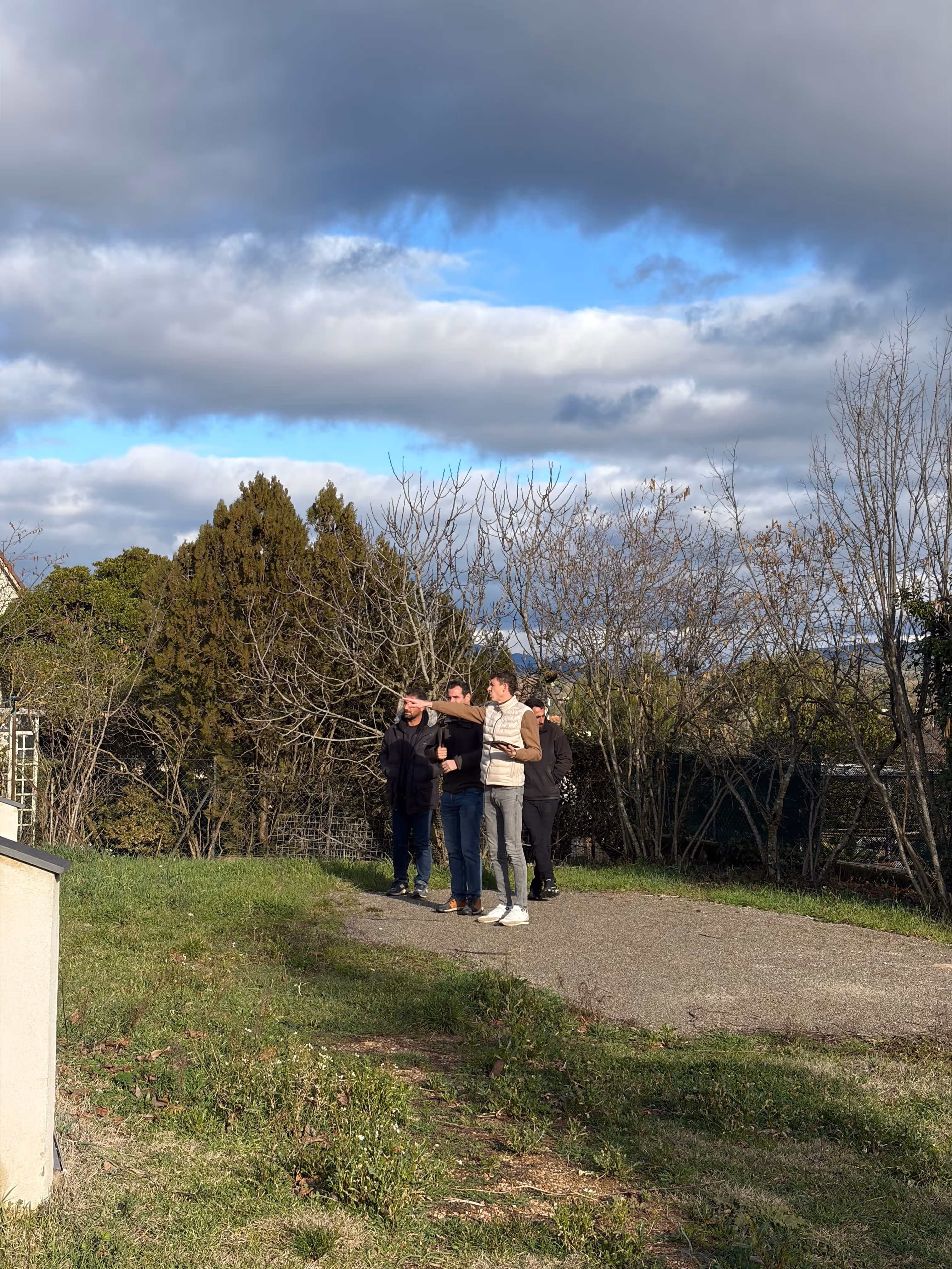 Deux personnes examinant un grand plan ou dessin technique dans un bureau lumineux.