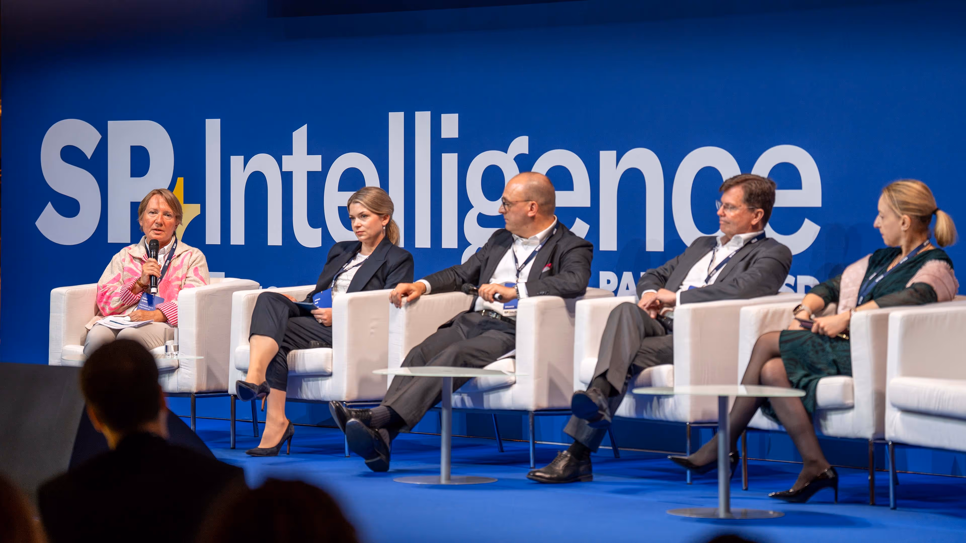 Five panelists seated on stage speaking at SP Intelligence Europe 2026, the Structured Products Conference.