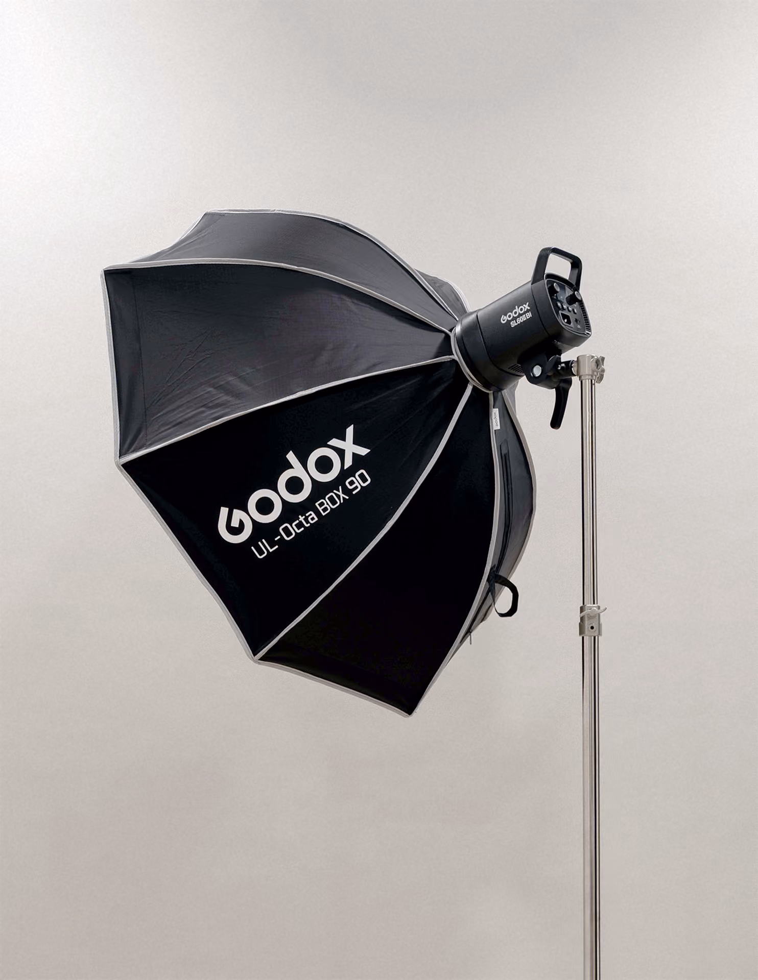 Godox UL-Octa BOX 90 black octagonal softbox attached to a studio light on a silver adjustable light stand against a plain light gray background.