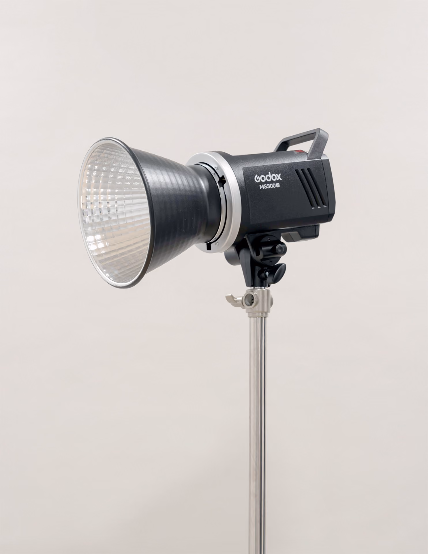 Godox MS300B studio light mounted on a metal stand with a reflective silver interior reflector cone, set against a neutral background.