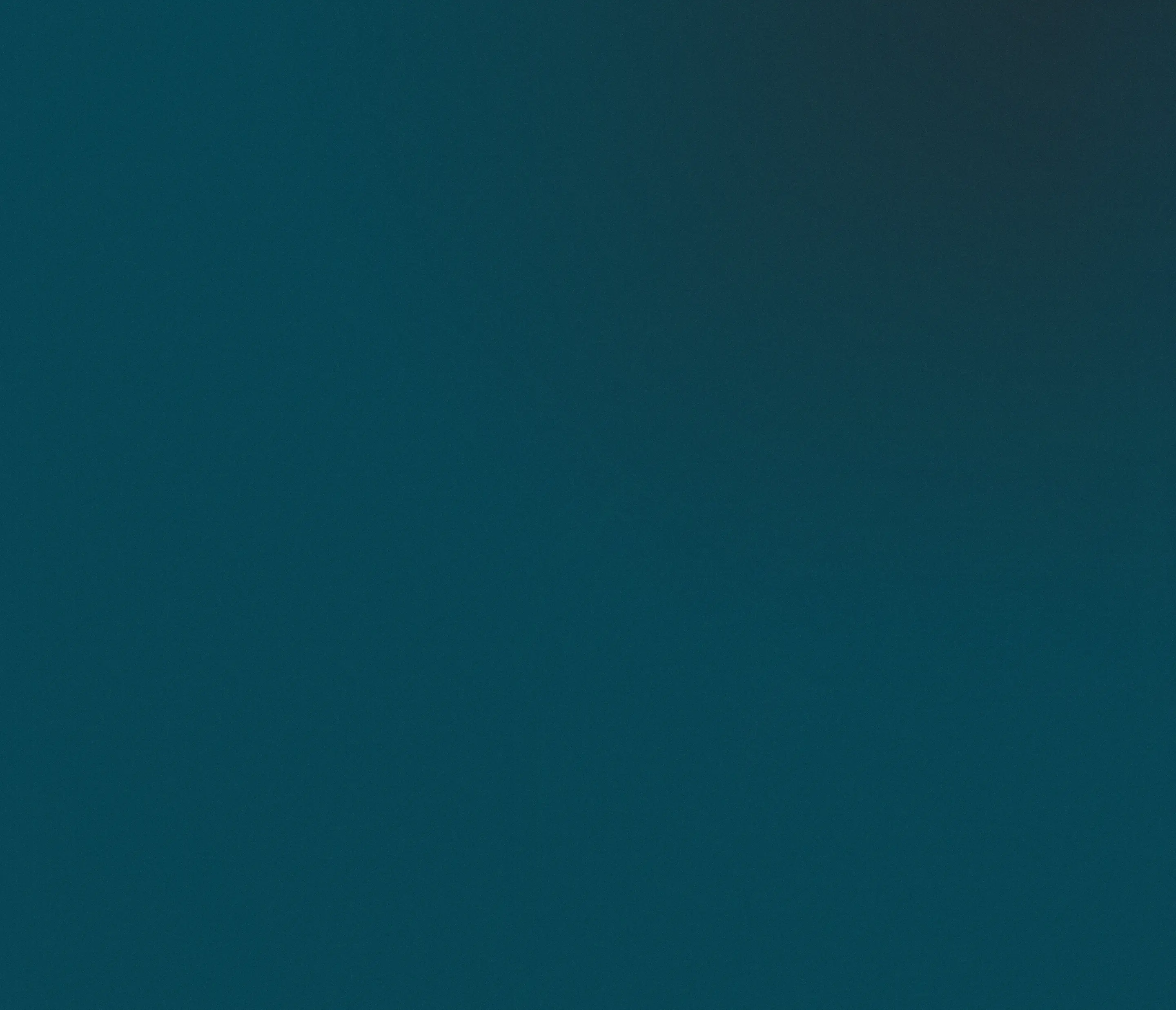 Solid dark teal color background.