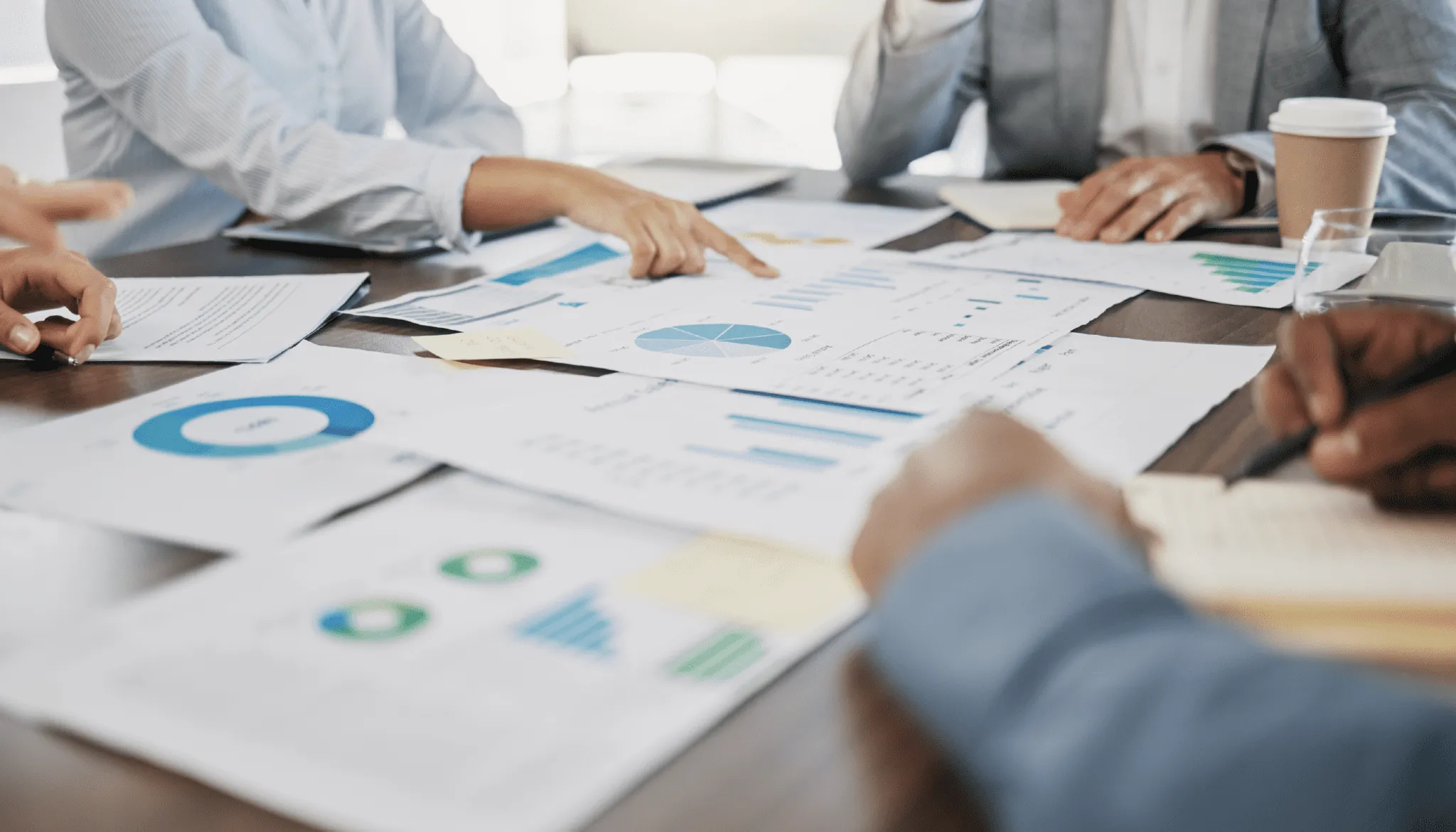 People reviewing finance reports for driver based modeling