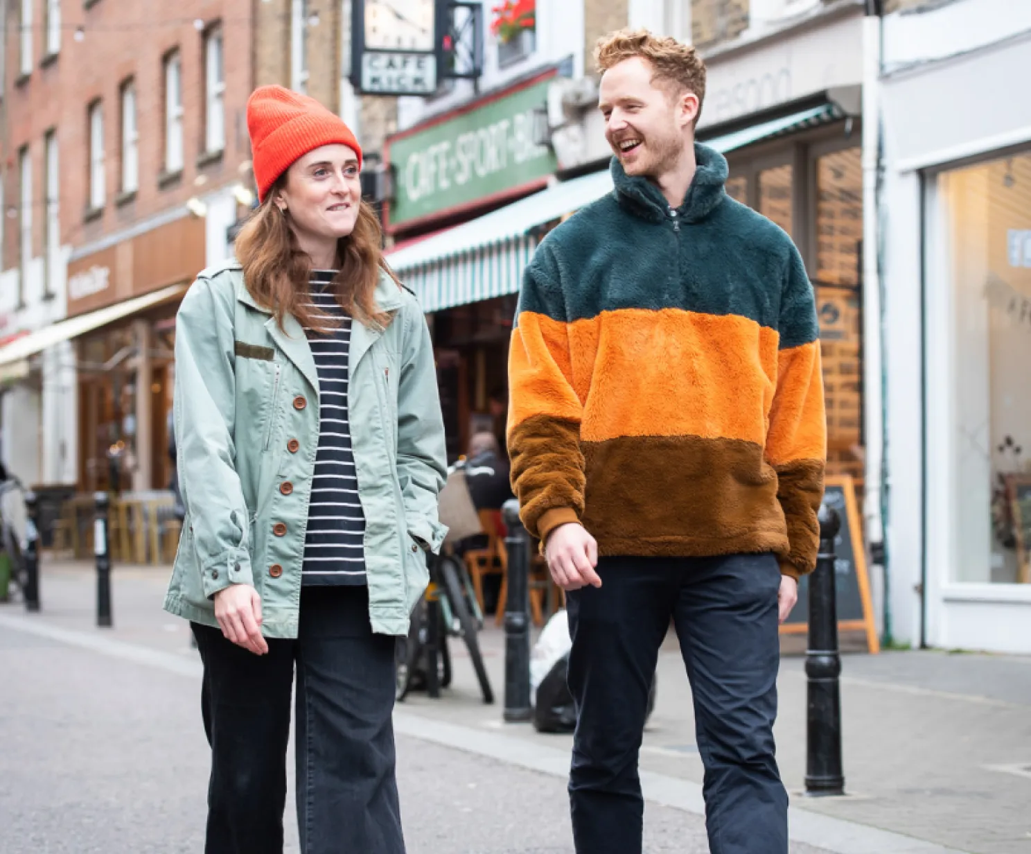 a man and a woman walking down the alley