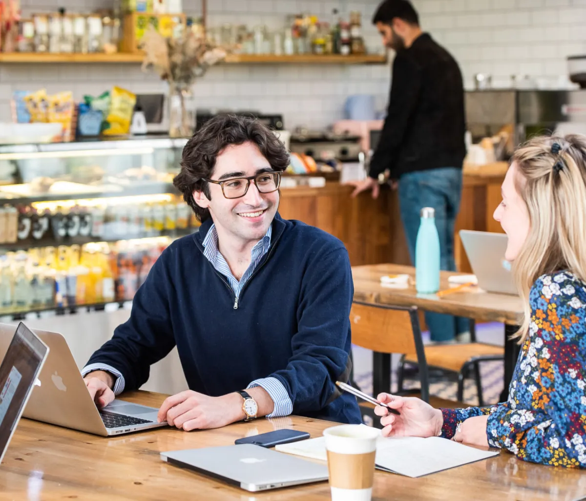 a man businessman discussing something with a woman businessman