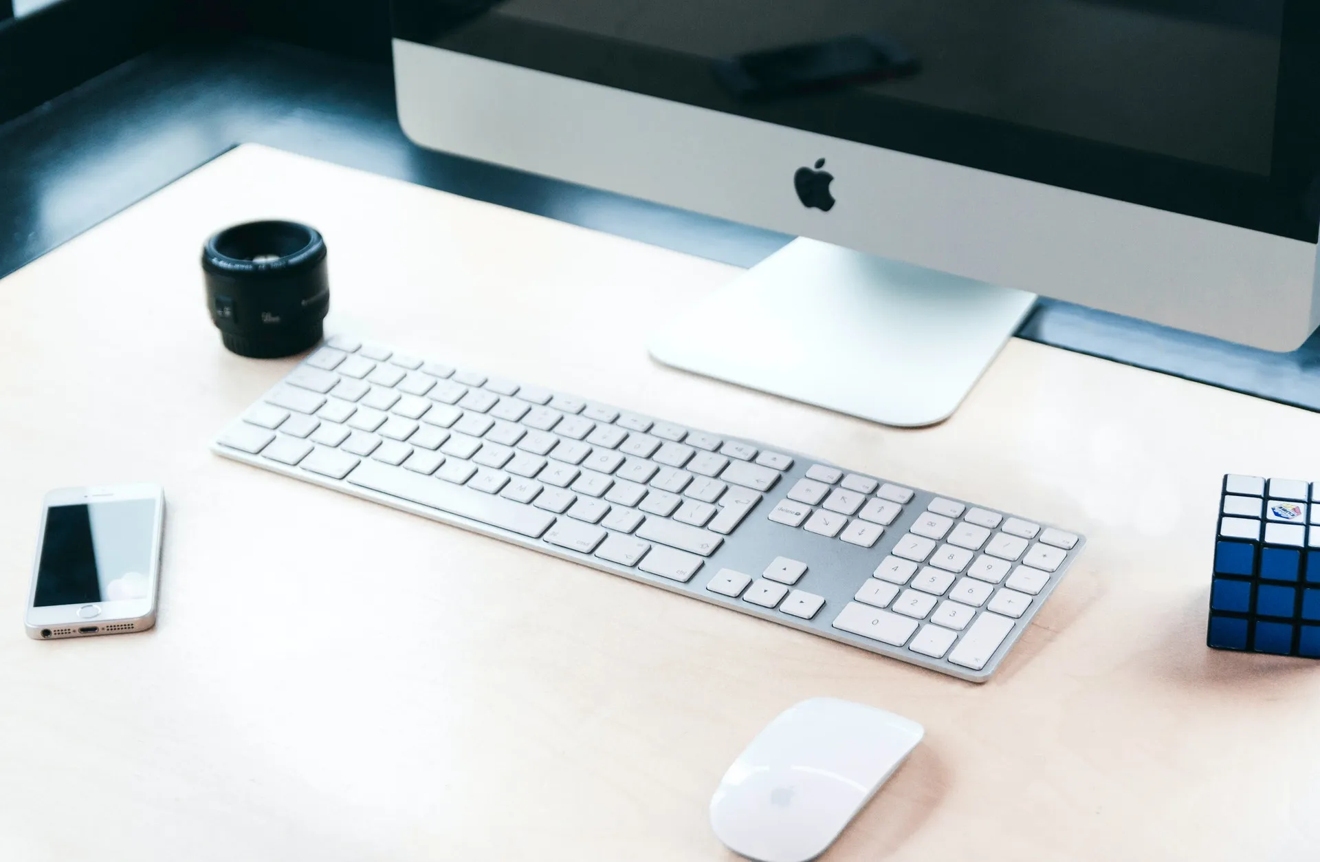 Close-up photo of a desk with a keyboard, a mouse and a monitor
