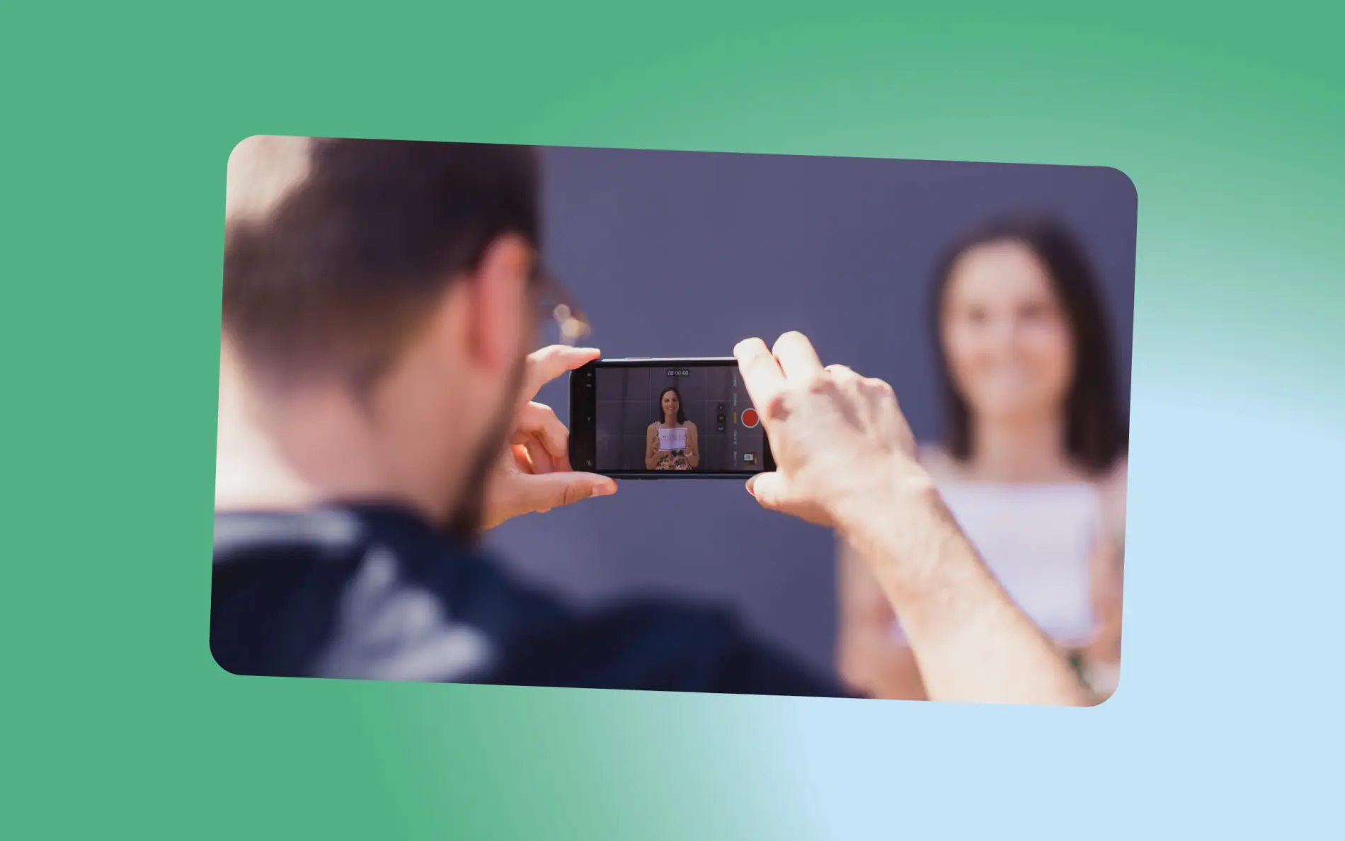 Man taking a video of a woman with his phone
