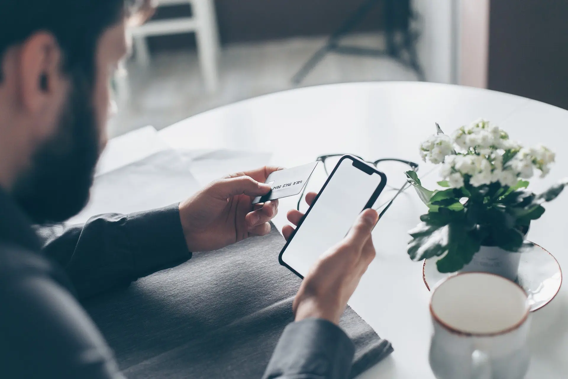 Close-up of a man making an online payment with a phone