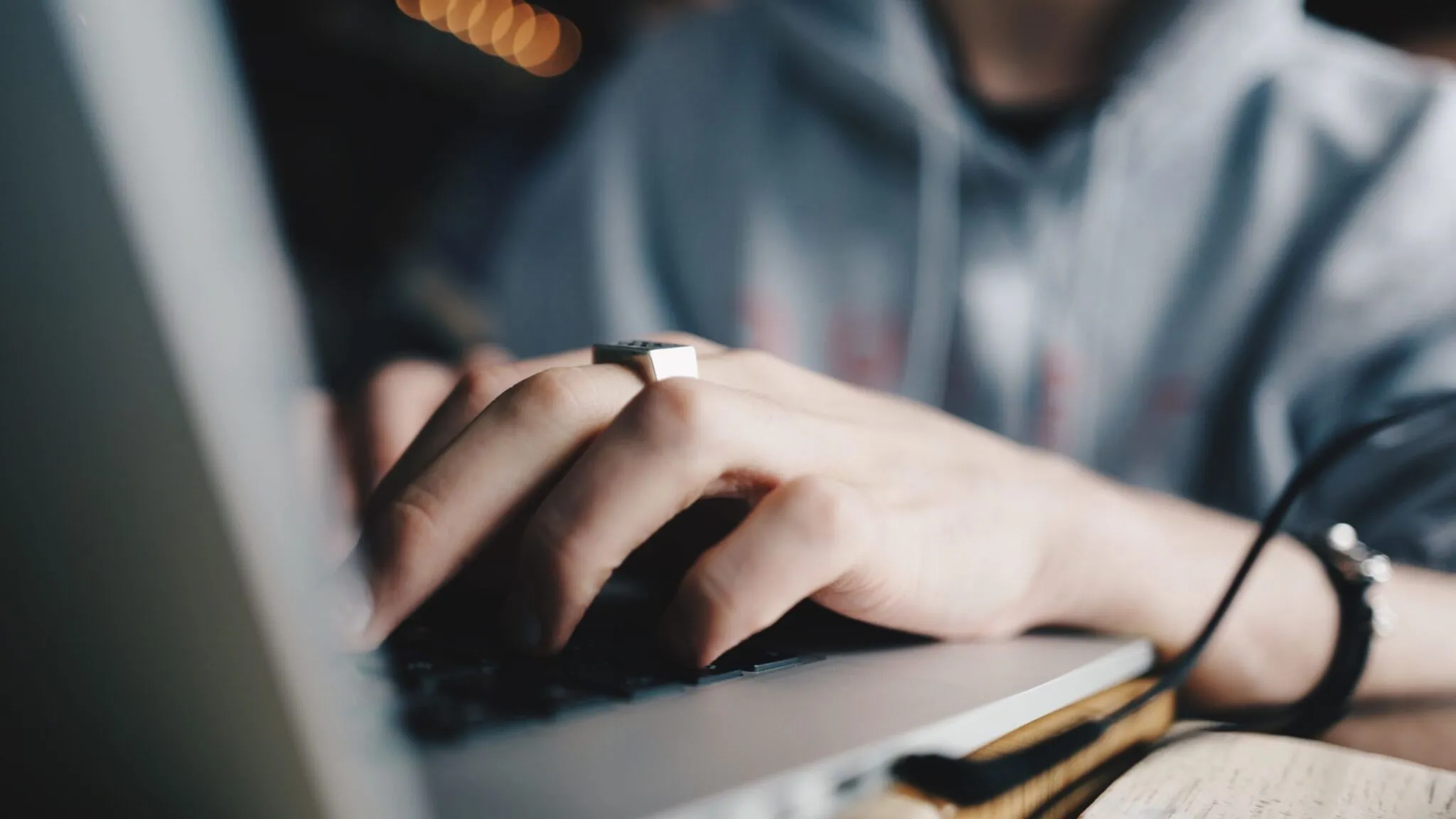 Close-up photo of a person working on a laptop