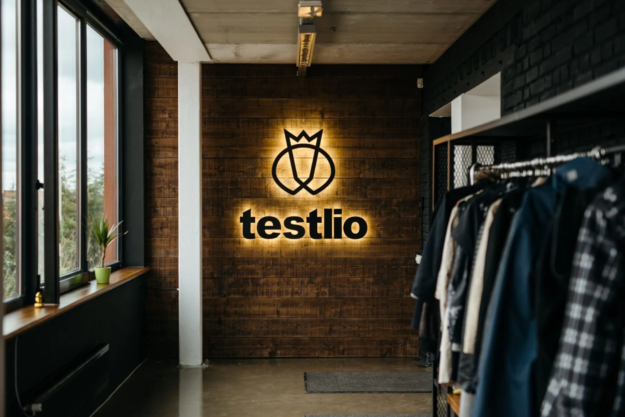 Testlio's logo on a wall