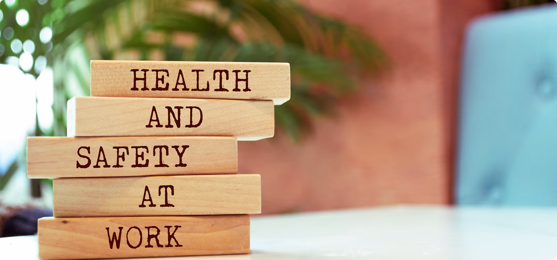 Stack of wooden blocks with the words 'Health and Safety at Work' printed on them.
