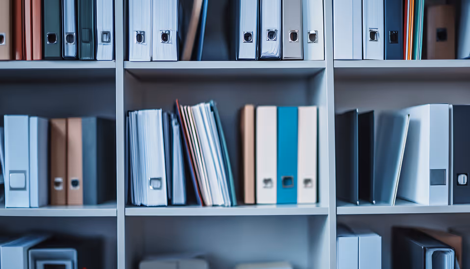 Shelves filled with organized binders and folders in various colors and sizes.