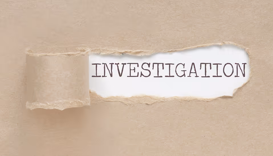 The word INVESTIGATION revealed under torn brown paper.