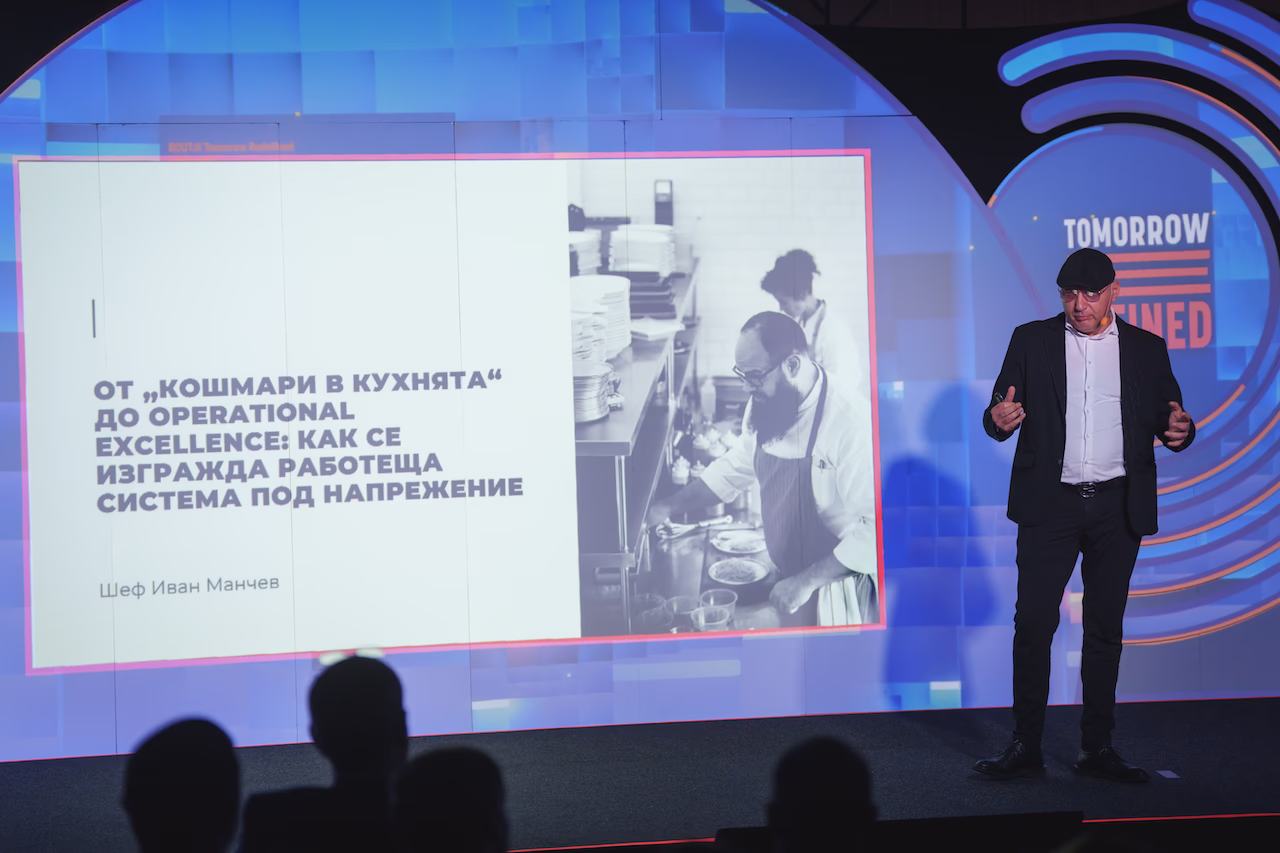 Шеф Иван Манчев изнася презентация за управлението на процеси и бизнес системи под напрежение на сцената.