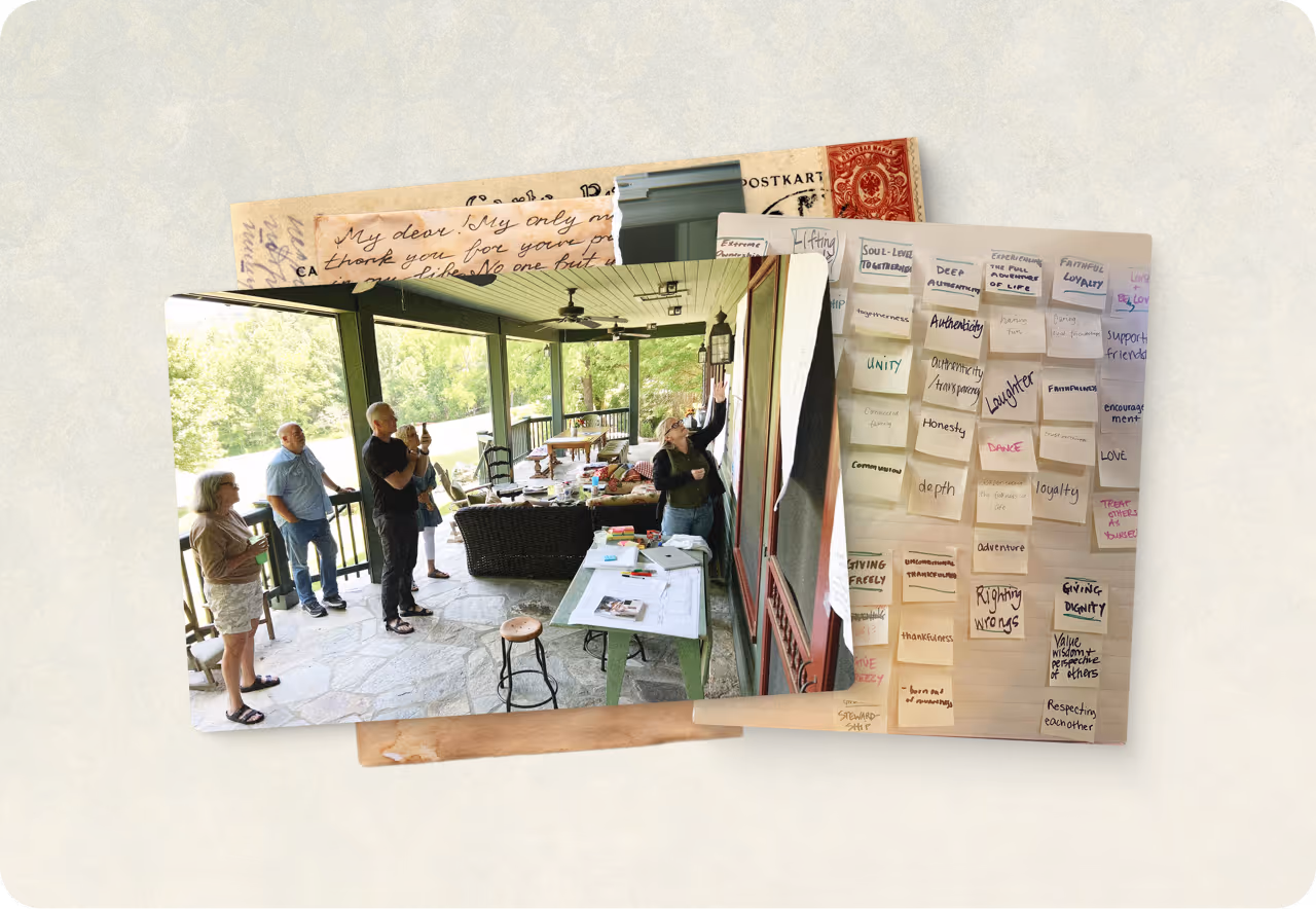 Group of five people standing on a covered stone patio, engaged in a discussion with notes and papers on a table.
