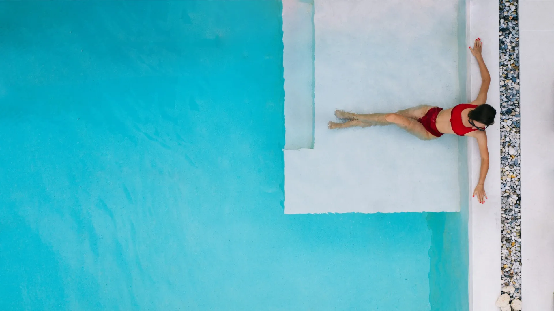 woman lying at the edge of a pool