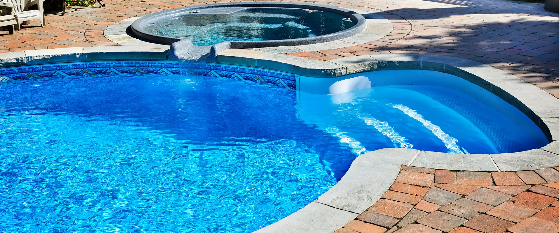 Rectangular residential pool with spacious tiled patio
