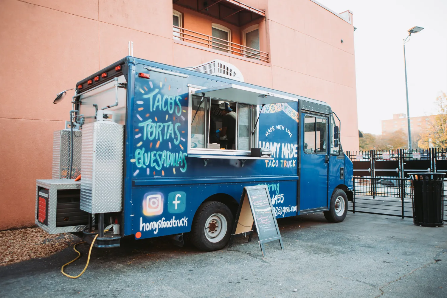 Blue food truck serving tacos, tortas, and quesadillas with a menu board outside.