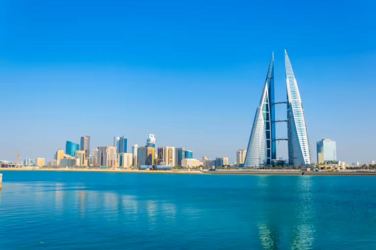 Skyline of Manama dominated by the World trade Center building during night, Bahrain