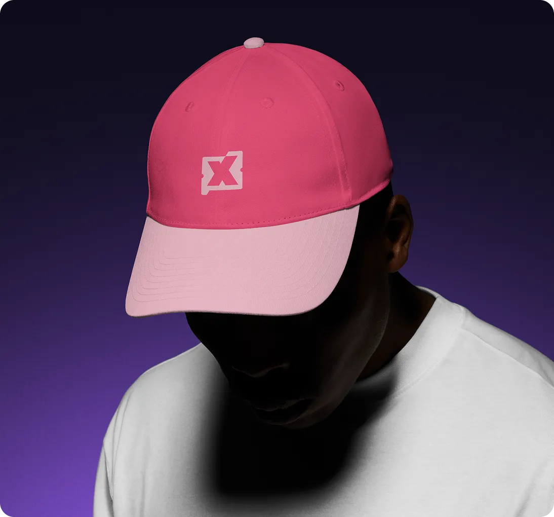 Person wearing a two-tone pink baseball cap with a white logo on the front, against a dark purple gradient background.