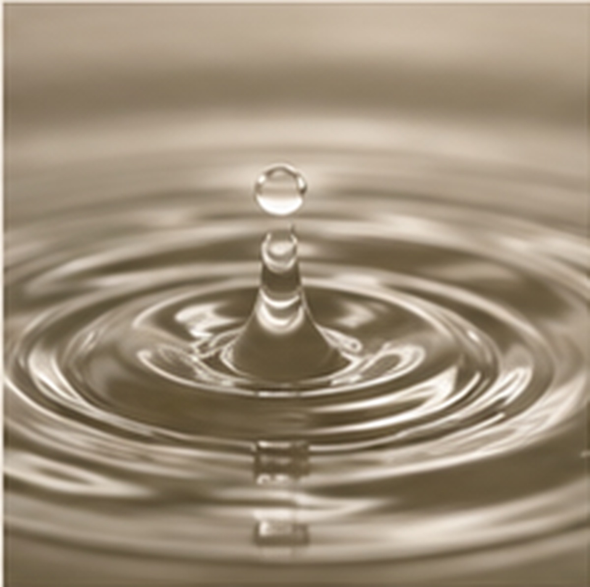 Water droplet falling into still water