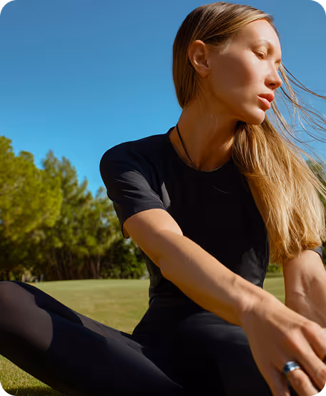 Woman stretching on a sunny day in the park