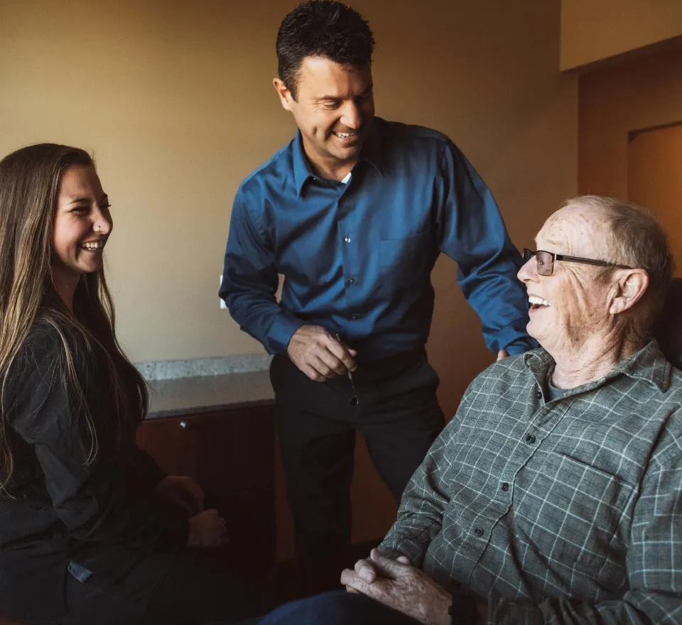 Dr. Jeff Loftus meeting with an older dental patient