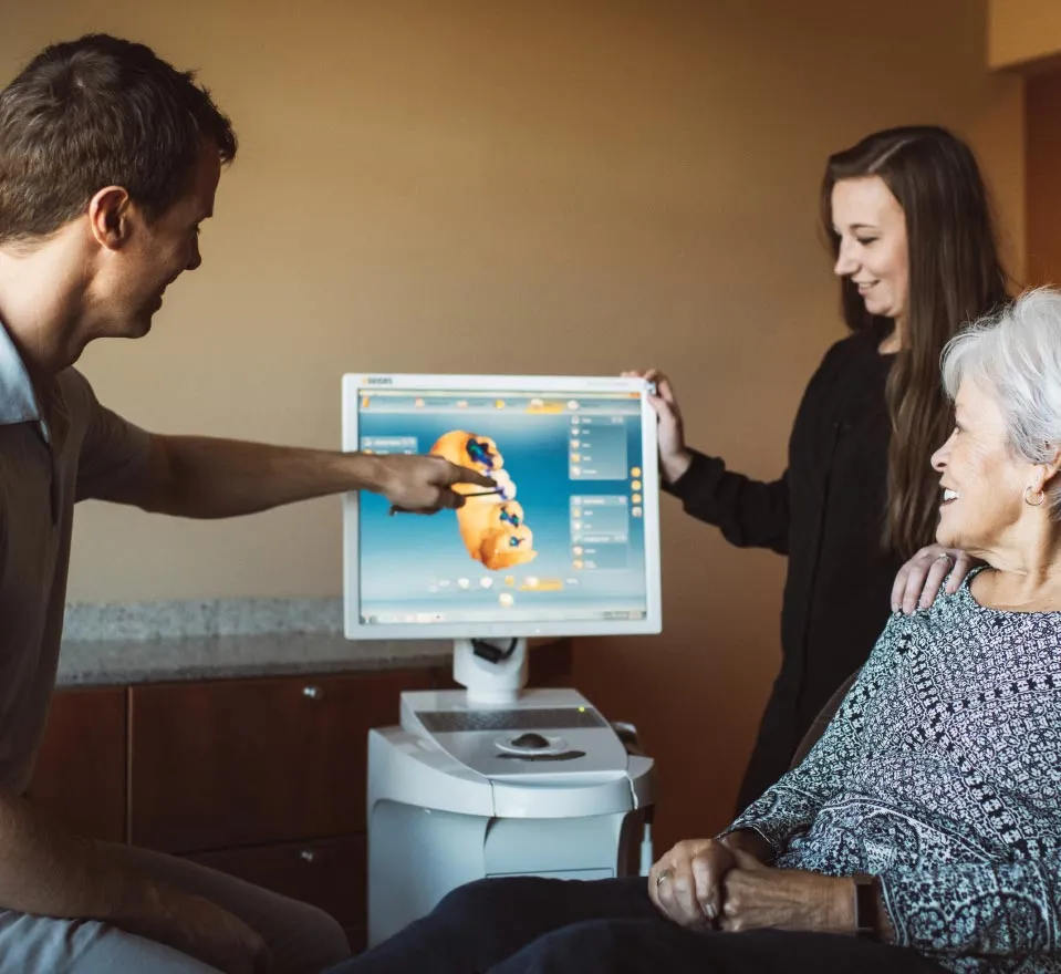 Dr. Rob showing a woman a 3d dental model