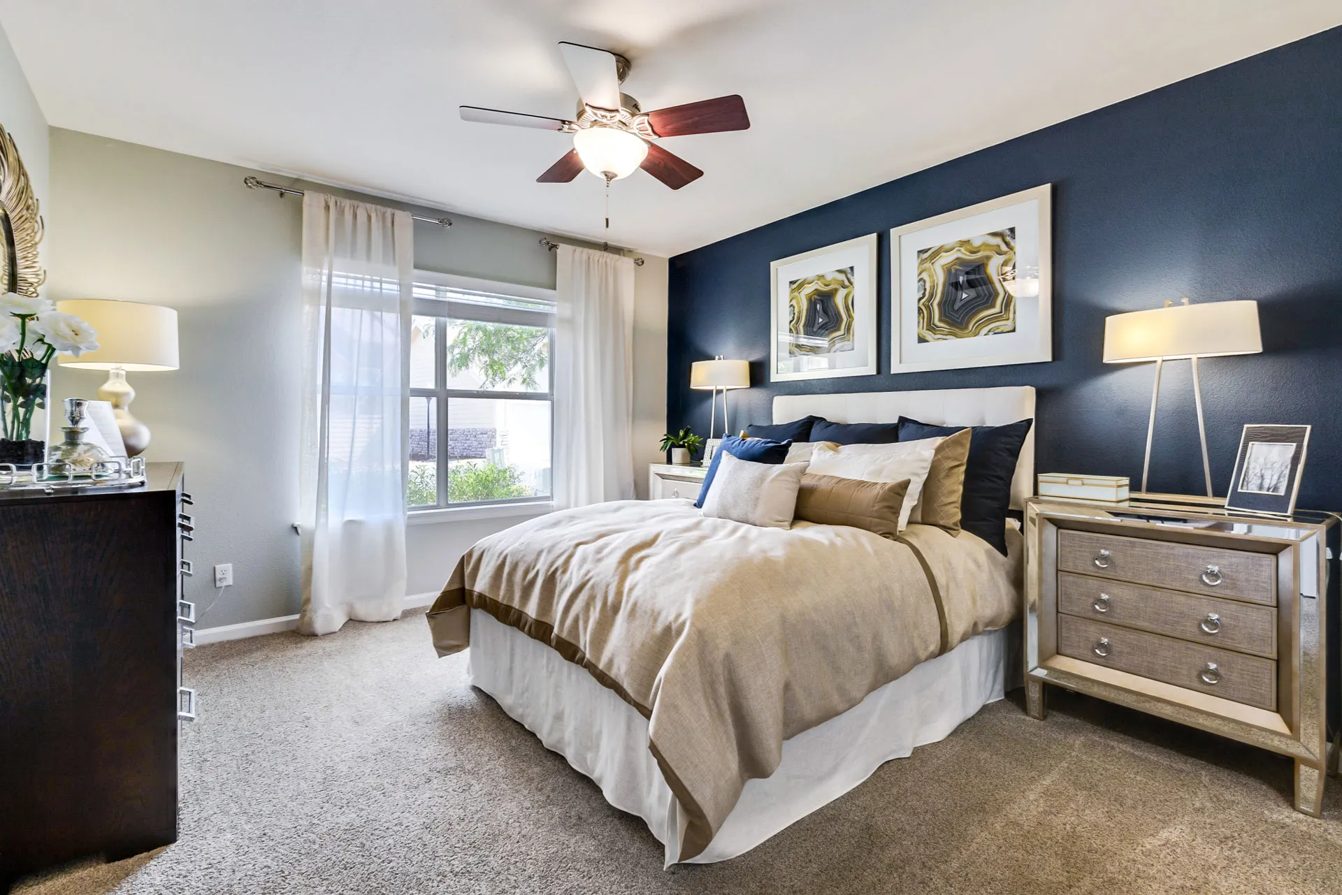 furnished bedroom with bed, wall decor, and wadrobes