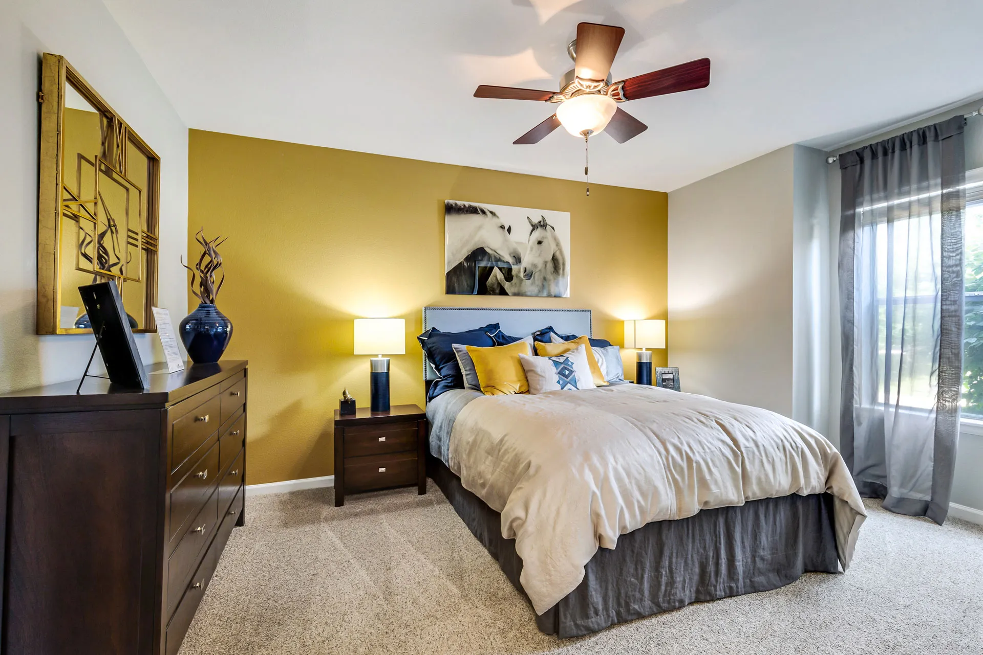 furbished bedroom with large windows, wall art and wadrobe