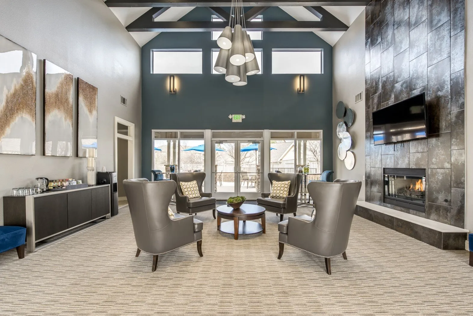 clubhouse seating area with chairs, tv, and fire place