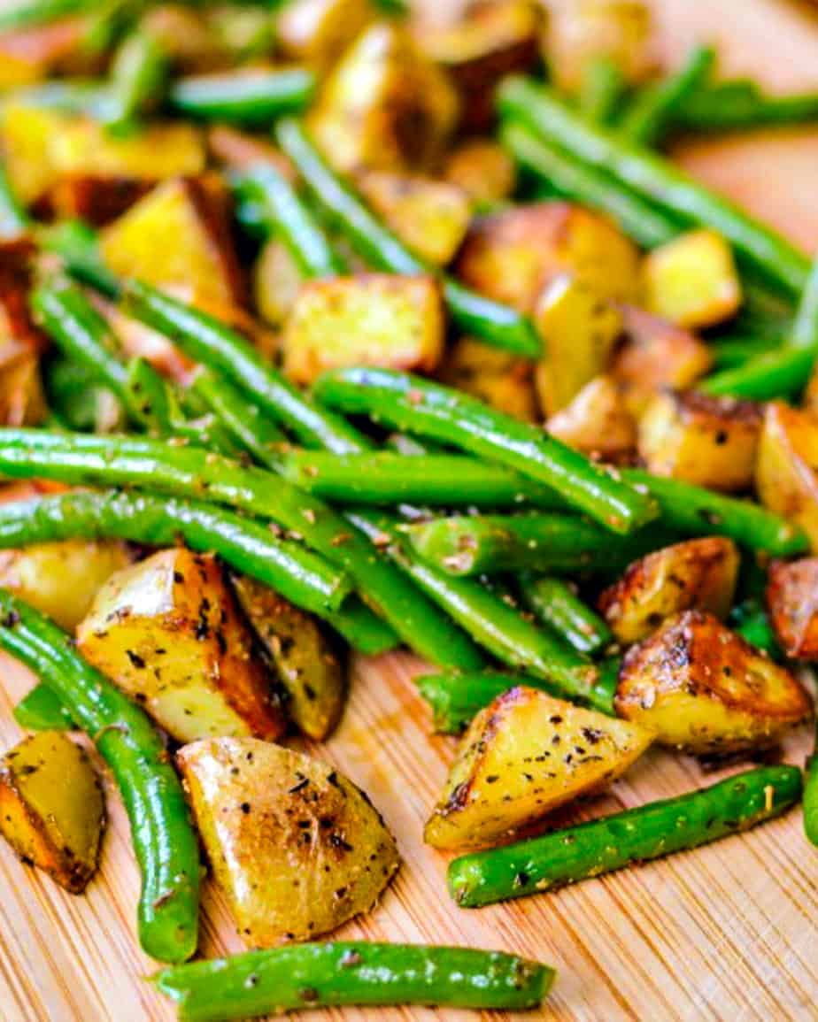 Sautéed green beans and potatoes on a cutting board