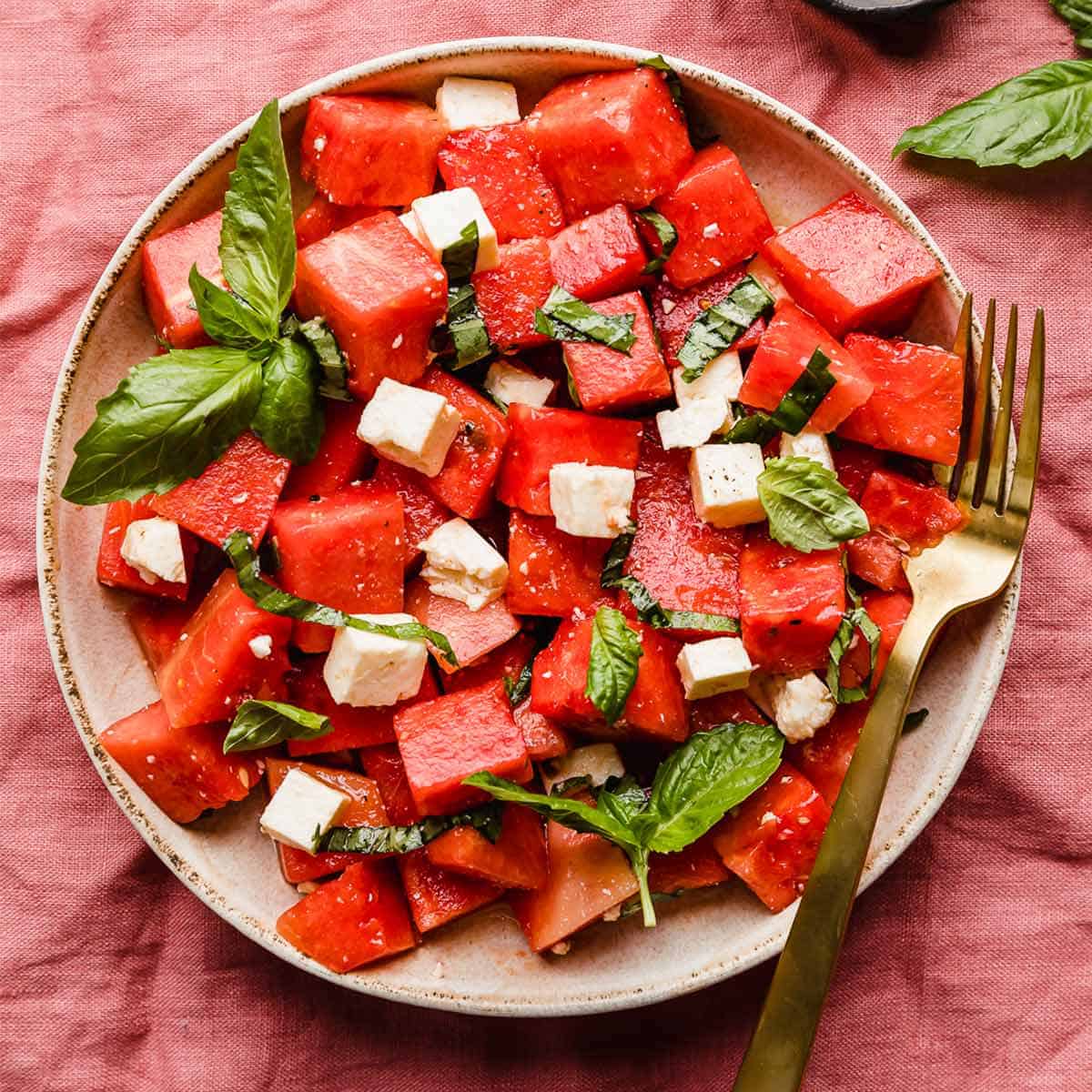 Watermelon feta basil salad with cubed watermelon, crumbled feta, and fresh basil ribbons